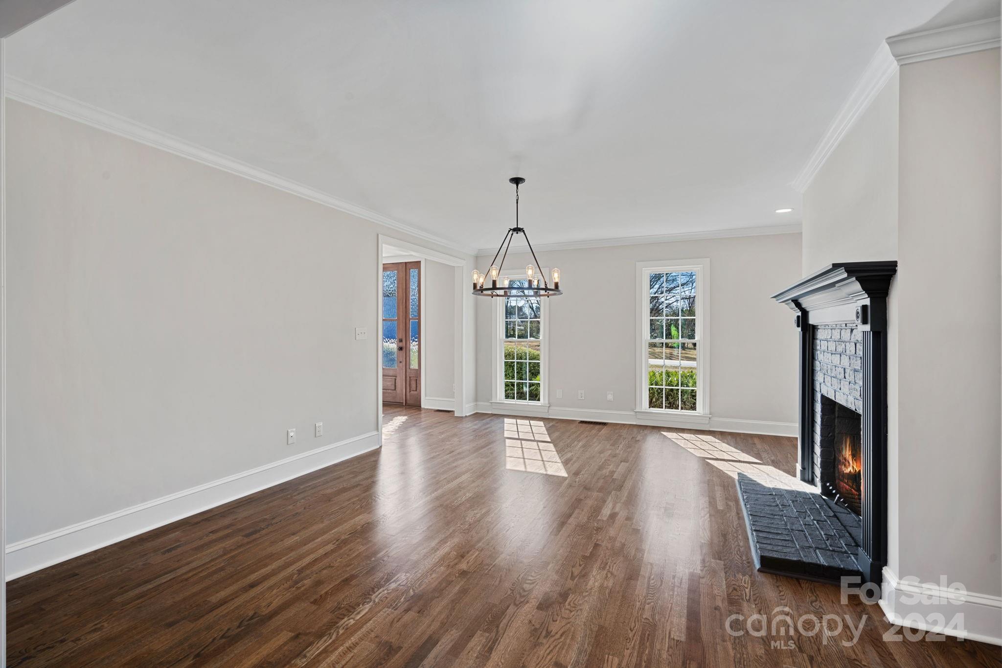 21140 Bethel Church Road Cornelius, NC 28031 - Photo 7 of 48 a view of an empty room with wooden floor and a window