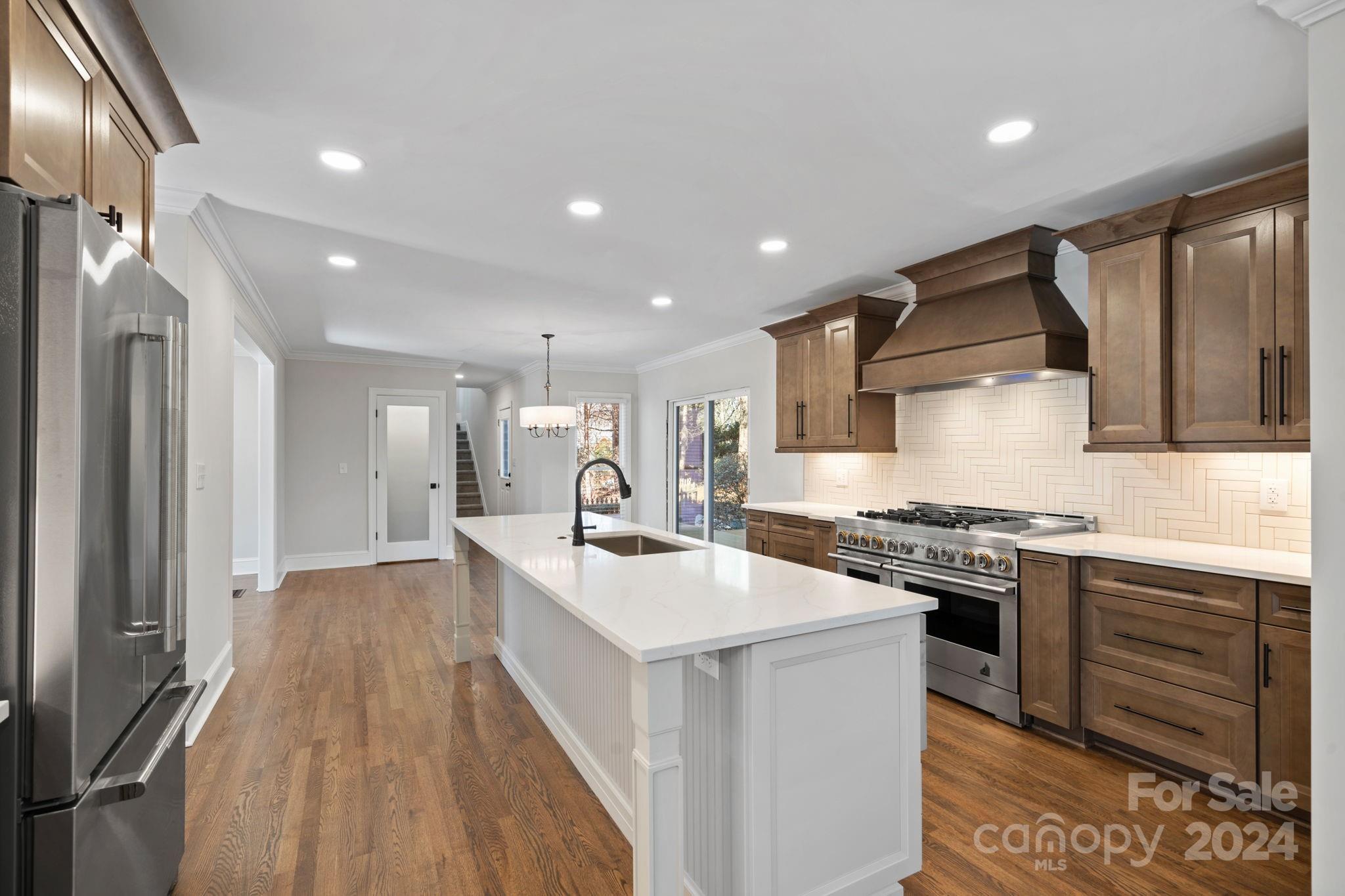 21140 Bethel Church Road Cornelius, NC 28031 - Photo 8 of 48 a kitchen with stove a sink and a refrigerator