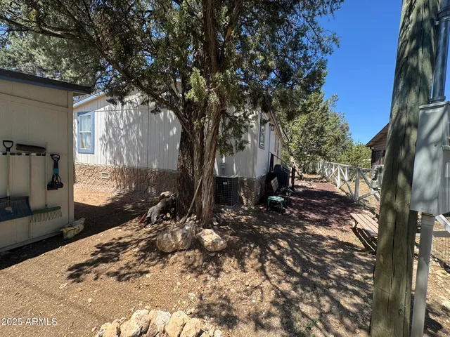 a living room with furniture ceiling fan and a flat screen tv