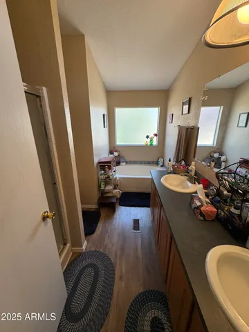 a bed room with furniture a flat screen tv and a window