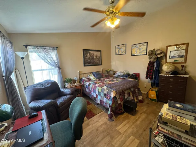 a living room with furniture a clock and a table