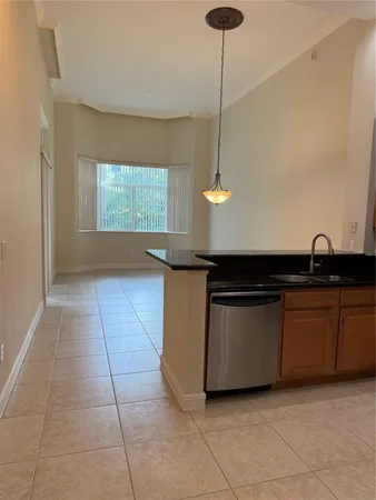 a kitchen with granite countertop a sink and a stove