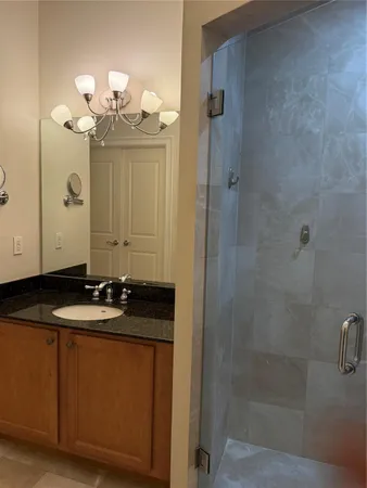 a bathroom with a granite countertop sink a toilet and a mirror