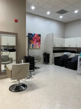 a living room with furniture a flat screen tv and kitchen view