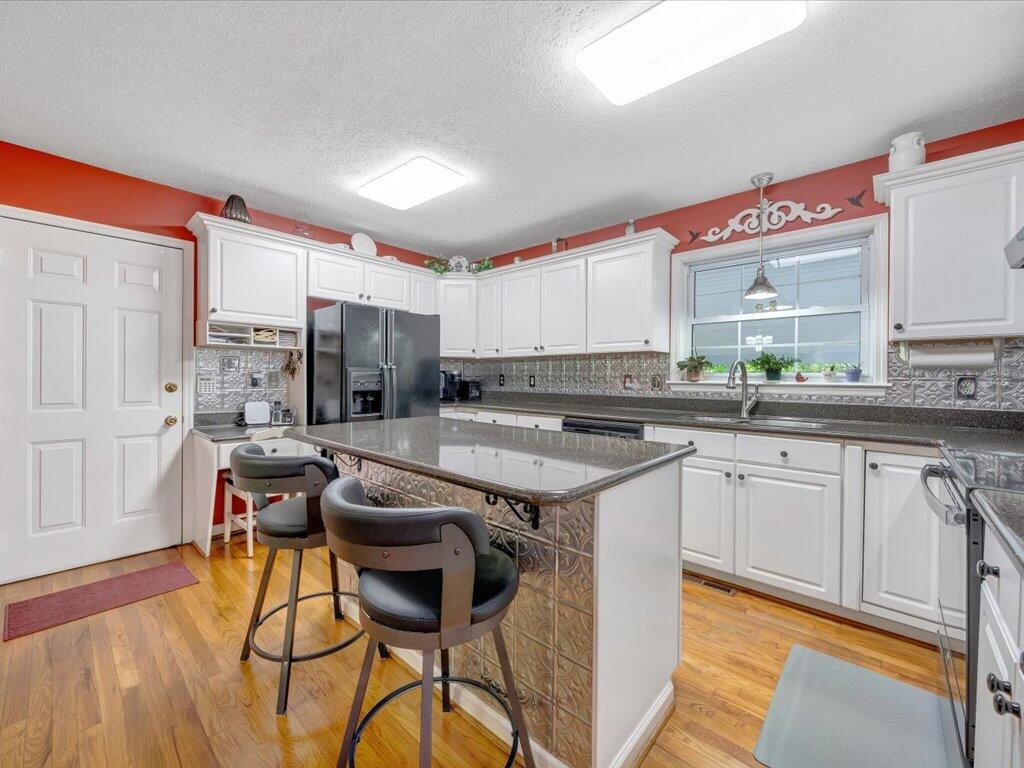 3475 Blue Knob Road Martinsville, VA 24112 - Photo 14 of 80 a kitchen with stainless steel appliances granite countertop a stove a sink dishwasher and a refrigerator with wooden floor