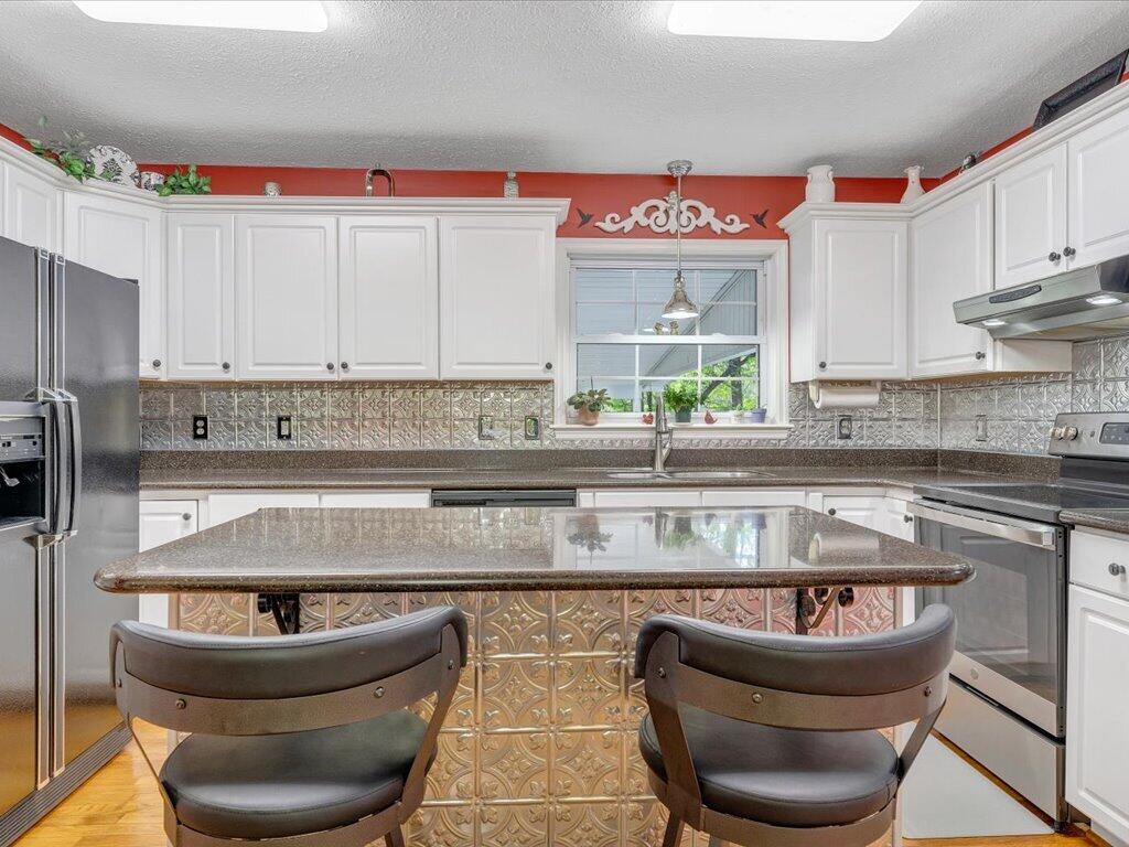 3475 Blue Knob Road Martinsville, VA 24112 - Photo 15 of 80 a kitchen with stainless steel appliances granite countertop a sink a stove and a granite counter tops