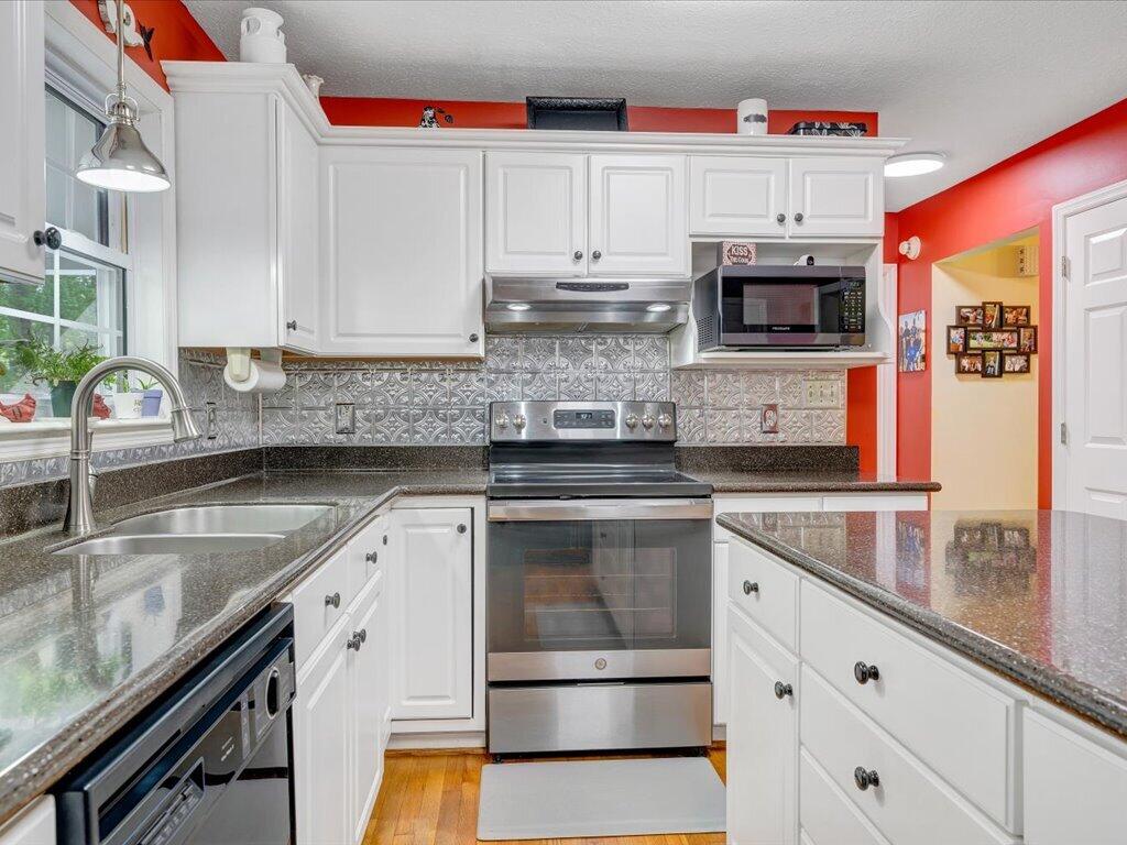 3475 Blue Knob Road Martinsville, VA 24112 - Photo 18 of 80 a kitchen with stainless steel appliances granite countertop a sink and a stove