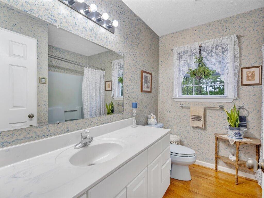 3475 Blue Knob Road Martinsville, VA 24112 - Photo 29 of 80 a bathroom with a granite countertop sink mirror and toilet