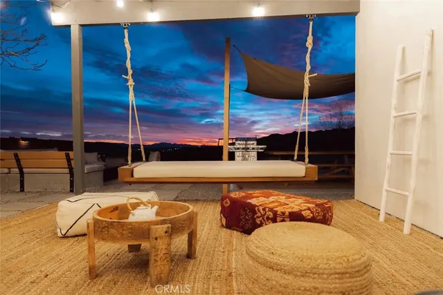 a view of a terrace with couches and lounge chairs