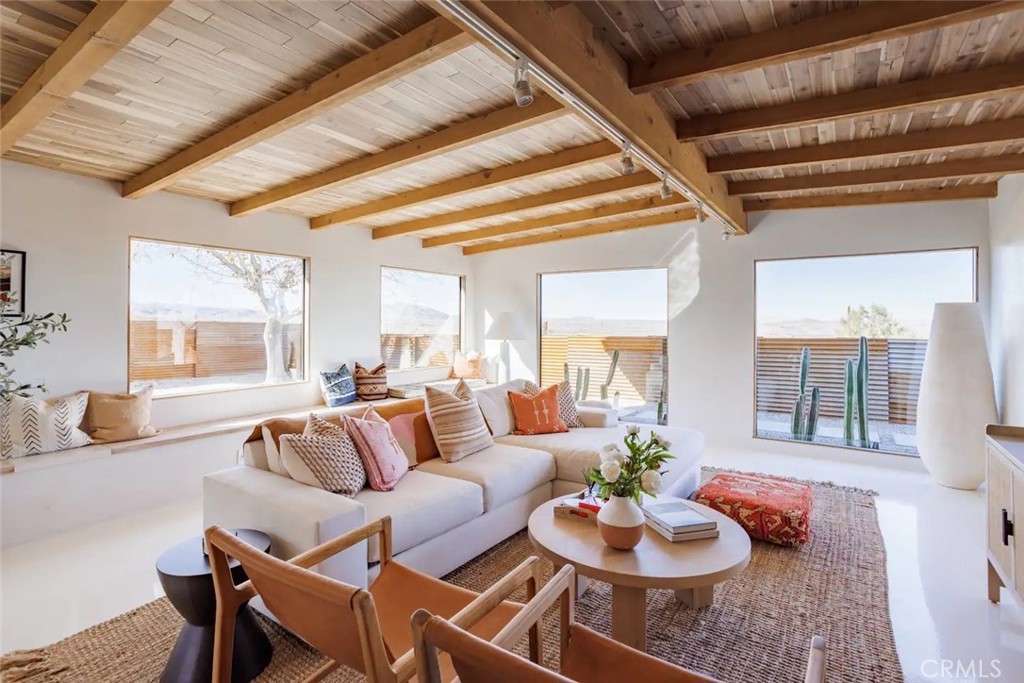 6979 White Feather Road Joshua Tree, CA 92252 - Photo 20 of 44 a living room with furniture and a large window