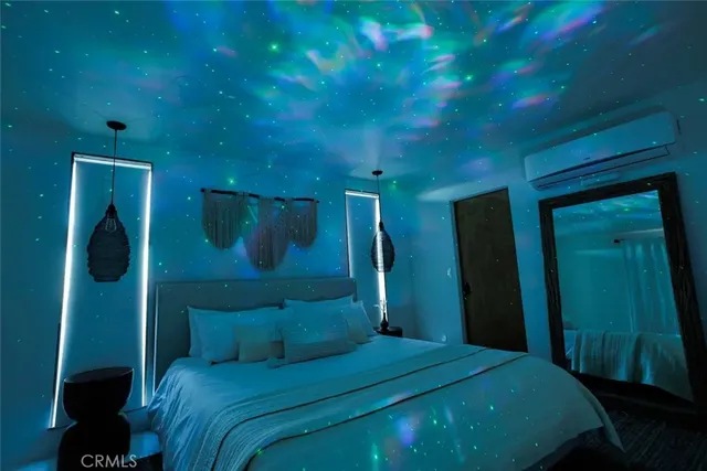 a bedroom with a bed a mirror and a window