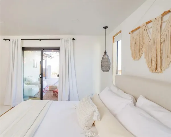 a bedroom with a bed and a large mirror