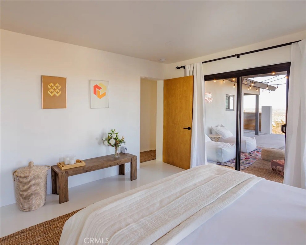 6979 White Feather Road Joshua Tree, CA 92252 - Photo 36 of 44 a bedroom with a bed and a large mirror