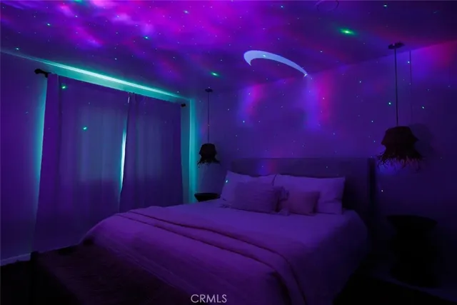 a bedroom with a bed and a night stand