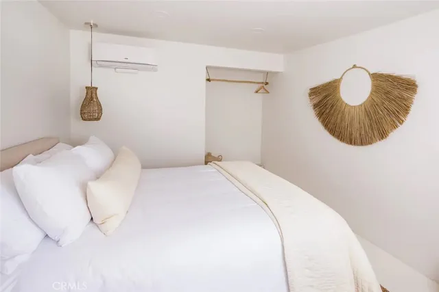 a bedroom with a bed and a potted plant