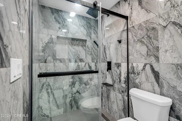 a bathroom with a toilet and shower