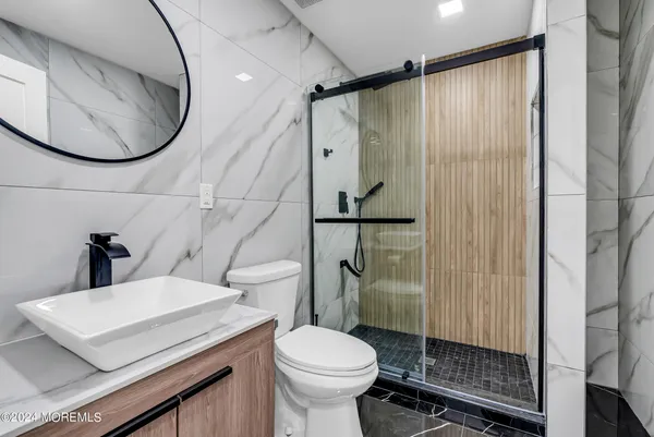 a bathroom with a toilet a sink and shower