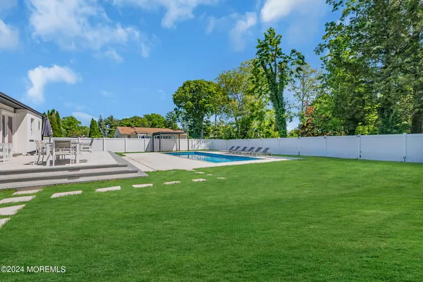 a view of pool with a yard