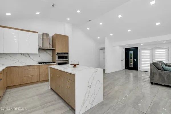 a kitchen with stainless steel appliances granite countertop a sink and cabinets
