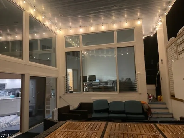 a view of hallway with wooden floor and staircase
