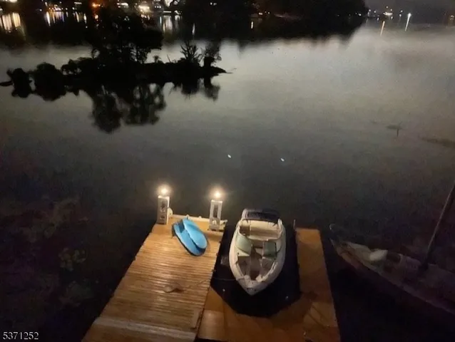 a view of a balcony with wooden floor and outdoor seating