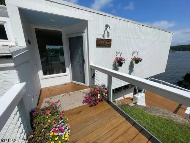 a view of a house with a window and wooden fence