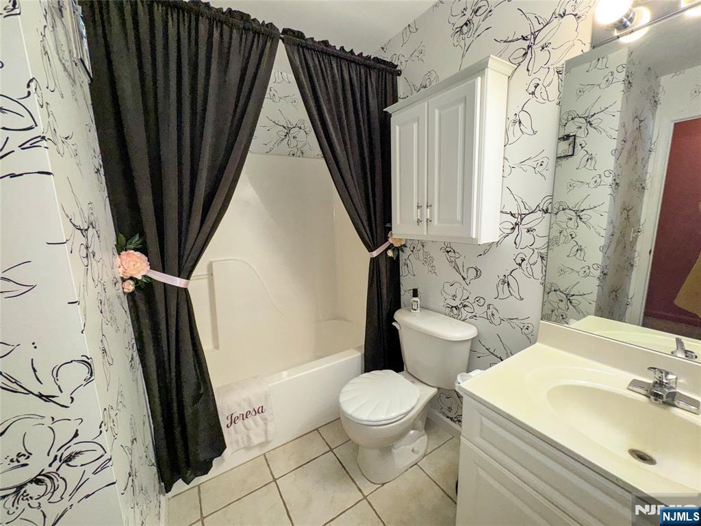 34 Chanda Court, Unit D034 Clifton, NJ 07012 - Photo 12 of 24 a bathroom with a sink a toilet a tub and shower