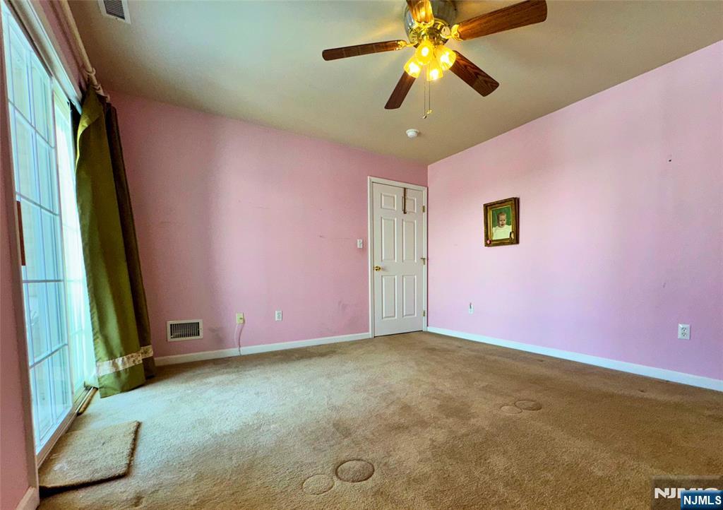 34 Chanda Court, Unit D034 Clifton, NJ 07012 - Photo 15 of 24 a view of a livingroom with a ceiling fan and window