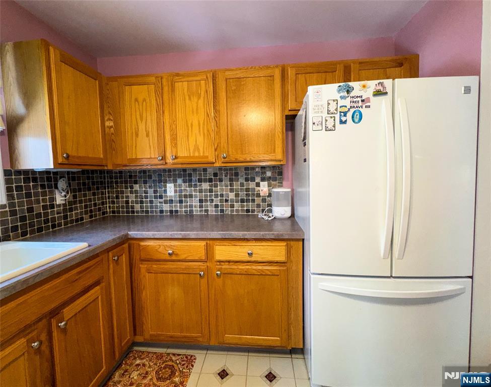 34 Chanda Court, Unit D034 Clifton, NJ 07012 - Photo 9 of 24 a bathroom with a sink a refrigerator and a window