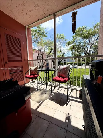 a building outdoor space with patio furniture and potted plants