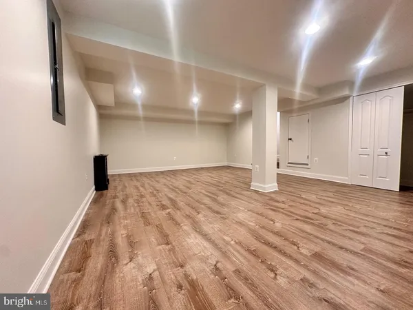 a view of empty room with wooden floor
