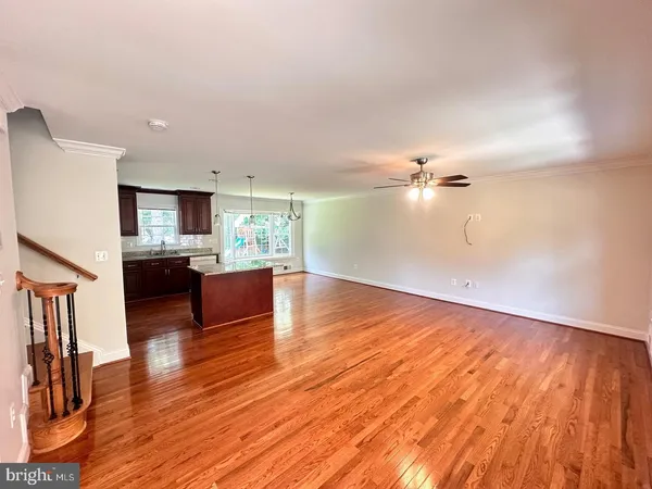 a view of kitchen and hall with wooden floor