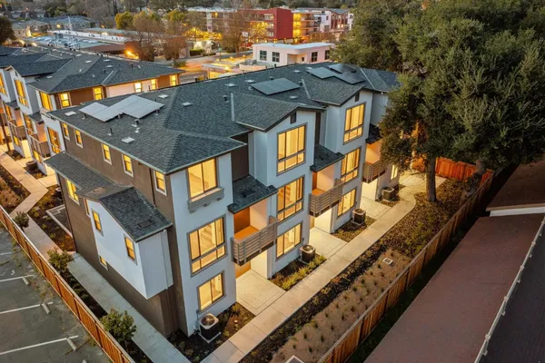 an aerial view of a residential apartment building with a yard