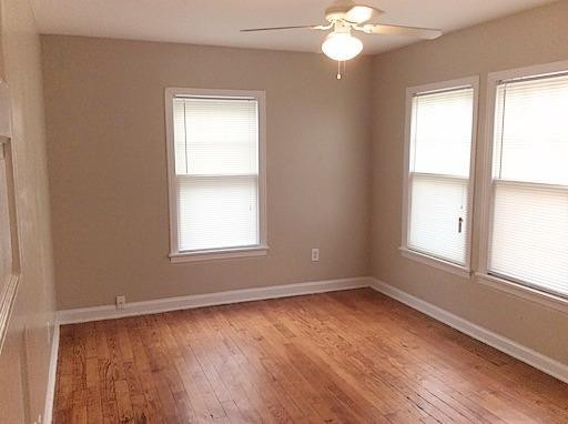 3405 24th Street Lubbock, TX 79410 - Photo 6 of 11 an empty room with wooden floor and windows