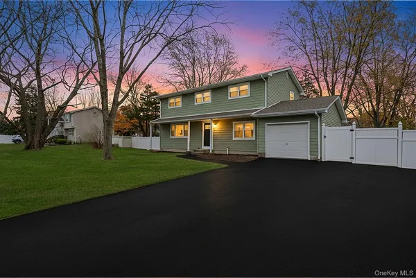 a front view of a house with a garden and yard