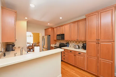 a kitchen with stainless steel appliances a sink and cabinets