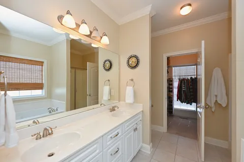 a spacious bathroom with a sink double vanity and a mirror
