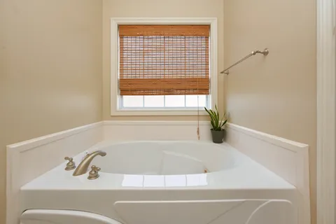 a white bath tub sitting next to a window