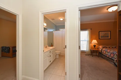 a en suite bathroom with a double vanity sink and a mirror