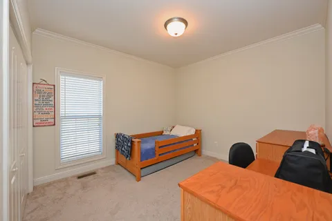 a bedroom with bed and a window