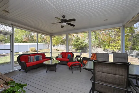 a living room filled with furniture and a large window
