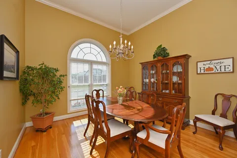 a view of a dining room with furniture and a chandelier