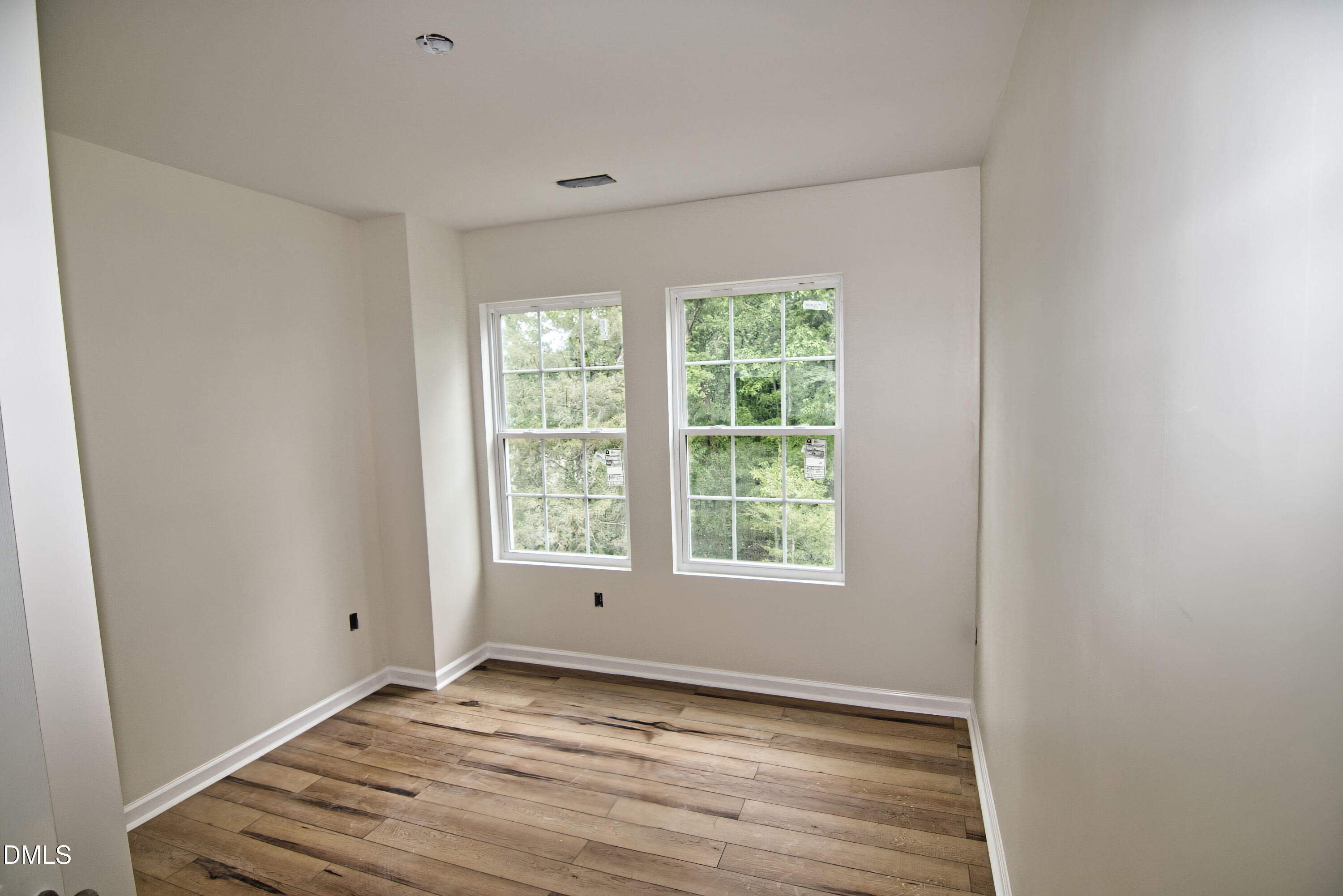 1009 Ridge Rock Road Raleigh, NC 27610 - Photo 6 of 8 a view of an empty room with wooden floor and a window