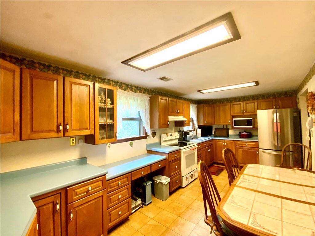 149 Noll Road Georgetown, PA 15043 - Photo 8 of 25 a view of a kitchen with kitchen island granite countertop a large window and furniture