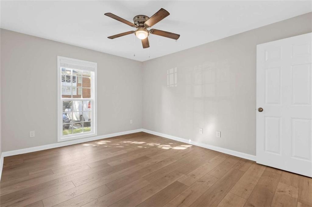 1166 Booth Road, Unit 407 Marietta, GA 30008 - Photo 12 of 18 an empty room with wooden floor and windows