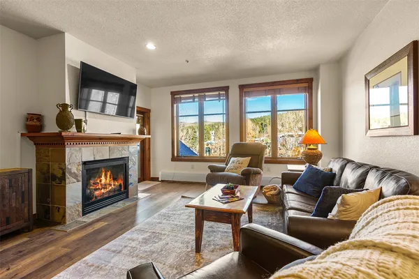 a living room with furniture and a fireplace