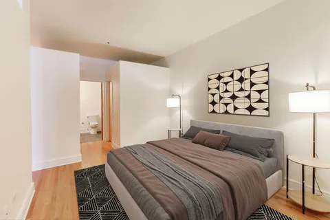 a bedroom with a bed and a lamp