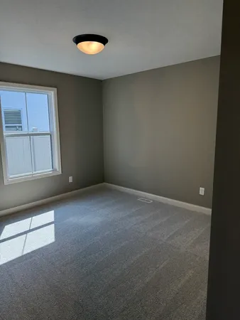 an empty room with windows and closet