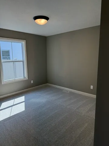 an empty room with windows and closet