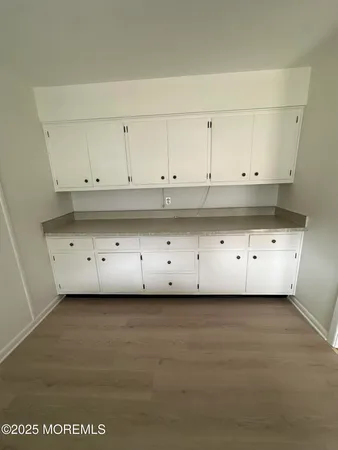 a kitchen with granite countertop a stove a sink and a refrigerator